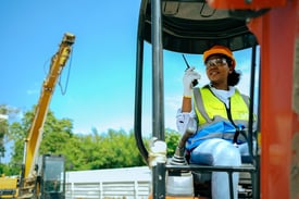 4-HR-Challenges-in-Construction-and-How-to-Solve-Them-Woman-worker-driving-backhoe-construction-site