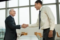 Businessmen shaking hands after successful hire