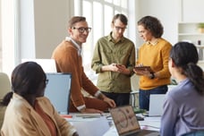 Engaged employees gathering around for a meeting